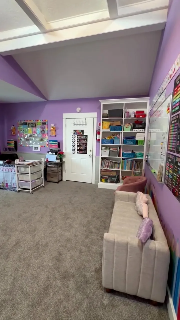 Reading couch beside shelves of books and bins